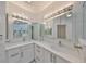 Double vanity bathroom with modern lighting at 4625 Mirabella Ct, St Pete Beach, FL 33706