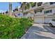 Front view of townhouse with private driveway and well-maintained landscaping at 4625 Mirabella Ct, St Pete Beach, FL 33706