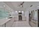 Modern white kitchen with stainless steel appliances and quartz countertops at 4625 Mirabella Ct, St Pete Beach, FL 33706