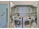 Laundry room with washer, dryer, and cabinets at 4625 Mirabella Ct, St Pete Beach, FL 33706