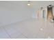 Bright living room with tile floors and access to balcony at 4625 Mirabella Ct, St Pete Beach, FL 33706