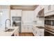 White kitchen with stainless steel appliances and quartz countertops at 5208 Savino Cir, Palmetto, FL 34221