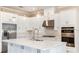 Spacious kitchen with white cabinets, stainless steel appliances, and quartz countertops at 5208 Savino Cir, Palmetto, FL 34221