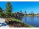 Landscaped walkway along pond with stonework at 5208 Savino Cir, Palmetto, FL 34221