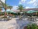 Outdoor patio area with tables and umbrellas near pool at 5208 Savino Cir, Palmetto, FL 34221