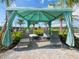 Relaxing poolside cabana with shaded seating and comfortable lounge chairs at 5208 Savino Cir, Palmetto, FL 34221