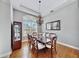 Elegant dining room features hardwood floors, a chandelier, and a large window at 5253 Mira Vista Dr, Palm Harbor, FL 34685