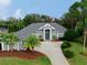 Two-story home with gray exterior, palm trees, and a landscaped yard at 5253 Mira Vista Dr, Palm Harbor, FL 34685