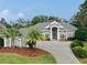 Gray house with a large driveway, landscaping, and palm trees at 5253 Mira Vista Dr, Palm Harbor, FL 34685