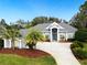 Attractive home with gray exterior, palm trees, and a large driveway at 5253 Mira Vista Dr, Palm Harbor, FL 34685