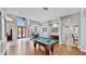 Game room with pool table, hardwood floors and views of entry and kitchen at 5253 Mira Vista Dr, Palm Harbor, FL 34685