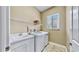 Bright laundry room with utility sink and shelving at 5253 Mira Vista Dr, Palm Harbor, FL 34685