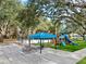 Community playground with play structures, picnic tables, and a shaded area at 5253 Mira Vista Dr, Palm Harbor, FL 34685