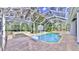 Screened pool and spa with basketball hoop at 5253 Mira Vista Dr, Palm Harbor, FL 34685