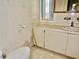 Bathroom with tiled walls, vanity, and toilet at 5341 Mary St, Zephyrhills, FL 33542