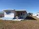 Side view of manufactured home with additional building at 5341 Mary St, Zephyrhills, FL 33542