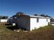 White manufactured home with a shed in the backyard at 5341 Mary St, Zephyrhills, FL 33542