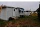 The exterior of a mobile home with steps and a small yard at 5341 Mary St, Zephyrhills, FL 33542