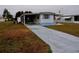 Front view of a mobile home with a driveway and landscaping at 5341 Mary St, Zephyrhills, FL 33542