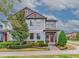 Two-story home with gray siding, red door, and landscaped front yard at 5716 Colony Glen Rd, Lithia, FL 33547