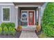 Inviting front porch with a red door, wreath, and stone walkway at 5716 Colony Glen Rd, Lithia, FL 33547