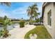 Landscaped backyard with a walkway leading to the canal at 5809 Cruiser Way, Tampa, FL 33615