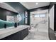 Modern bathroom with a double vanity and marble shower at 5809 Cruiser Way, Tampa, FL 33615