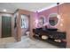 Elegant bathroom with double sinks, backlit mirrors, and a pink accent wall at 5809 Cruiser Way, Tampa, FL 33615