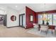 Elegant dining room featuring a modern chandelier, a stylish accent wall, and views of the outdoor landscape at 5809 Cruiser Way, Tampa, FL 33615