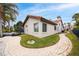 Exterior view of the house, showcasing a beige stucco exterior and a nicely landscaped yard at 5809 Cruiser Way, Tampa, FL 33615