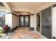 Covered front porch with brick pavers, double doors, and decorative plants, creating a warm and welcoming entrance at 5809 Cruiser Way, Tampa, FL 33615