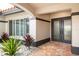 Inviting front entrance with brick pavers, double doors, and decorative plants, adding curb appeal to this charming home at 5809 Cruiser Way, Tampa, FL 33615