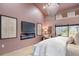 Serene main bedroom with a modern fireplace and luxurious bedding at 5809 Cruiser Way, Tampa, FL 33615