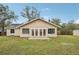 Backyard view of house with large lawn and patio at 5915 29Th Avenue E Dr, Bradenton, FL 34208