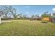 Large backyard with green grass and wooden fence at 5915 29Th Avenue E Dr, Bradenton, FL 34208