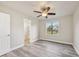 Bedroom with vinyl flooring, ceiling fan and bathroom access at 5915 29Th Avenue E Dr, Bradenton, FL 34208