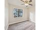 Bedroom with grey vinyl flooring and ceiling fan at 5915 29Th Avenue E Dr, Bradenton, FL 34208