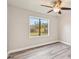 Bedroom with vinyl flooring and backyard view at 5915 29Th Avenue E Dr, Bradenton, FL 34208