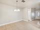 Bright dining area with tile floors and a modern chandelier at 5915 29Th Avenue E Dr, Bradenton, FL 34208