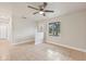 Bright living room with tile floors and ceiling fan at 5915 29Th Avenue E Dr, Bradenton, FL 34208