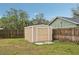 Tan colored storage shed in backyard, next to fence at 5915 29Th Avenue E Dr, Bradenton, FL 34208