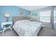 Bedroom with wicker bed, coastal decor and water views at 6051 Sun Blvd # 207, St Petersburg, FL 33715