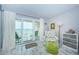 Relaxing bedroom with water view, comfortable armchair and coastal decor at 6051 Sun Blvd # 207, St Petersburg, FL 33715