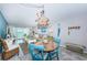 Charming dining area with rustic table and blue chairs at 6051 Sun Blvd # 207, St Petersburg, FL 33715