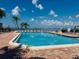 Community pool with water view and lounge chairs at 6051 Sun Blvd # 207, St Petersburg, FL 33715