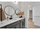 Stylish bathroom with gray cabinets, quartz countertop, and double vanity at 6137 Voyagers Pl, Apollo Beach, FL 33572