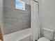 Clean bathroom with a tub, shower, and gray tile at 6137 Voyagers Pl, Apollo Beach, FL 33572