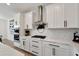 Modern kitchen with white cabinets, stainless steel appliances, and quartz countertops at 6137 Voyagers Pl, Apollo Beach, FL 33572