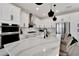 Modern kitchen with white cabinets, quartz countertops, and stainless steel appliances at 6137 Voyagers Pl, Apollo Beach, FL 33572