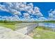 Scenic community lake with a wooden footbridge at 6137 Voyagers Pl, Apollo Beach, FL 33572